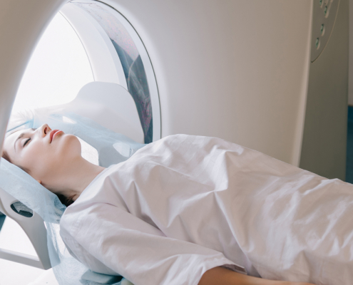 Women patient lying on a bed having a PET/CT scan of her head
