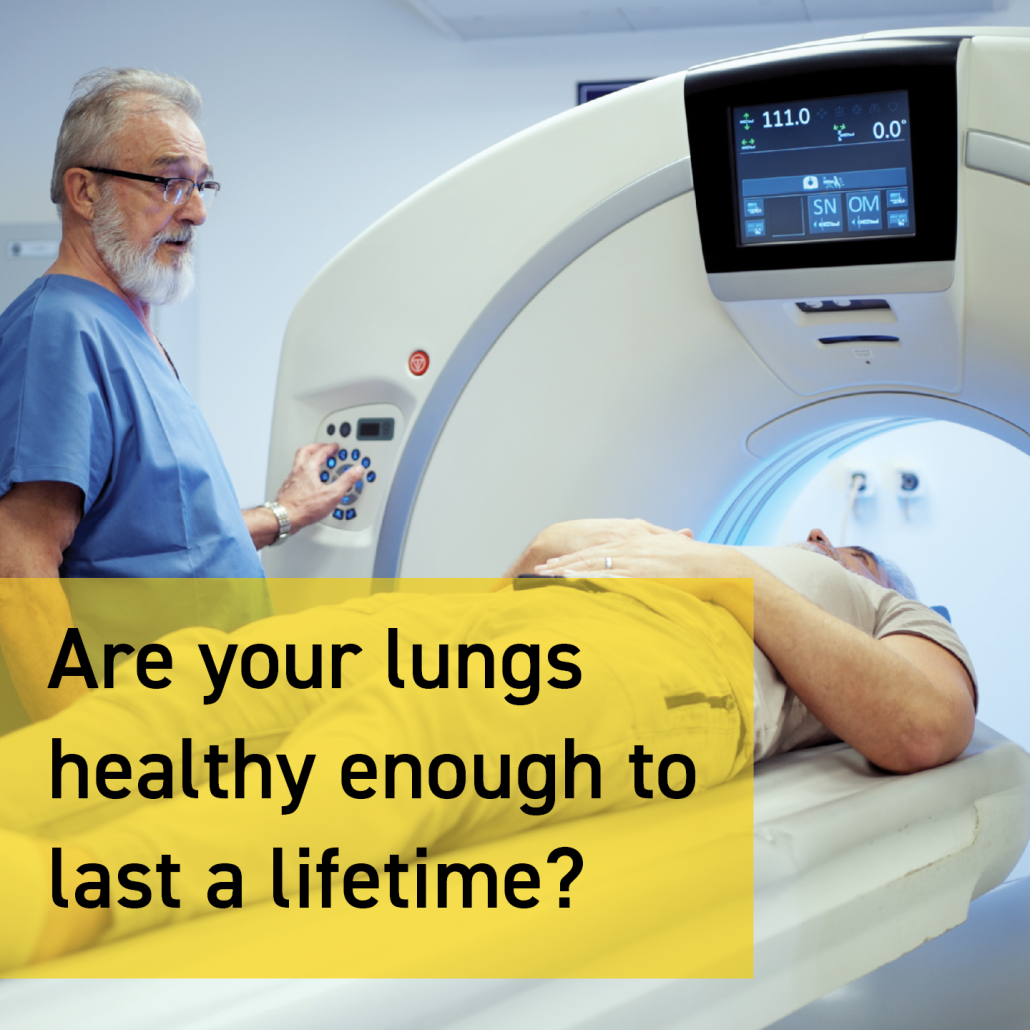Radiographer standing in front of a CT machine with a patient lying down for a lung cancer scan for lung cancer awareness